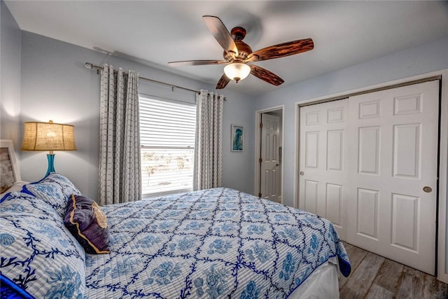 bedroom featuring ceiling fan, a closet, and light wood-type flooring