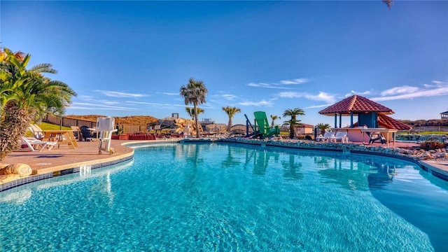 view of swimming pool with a gazebo and a patio area