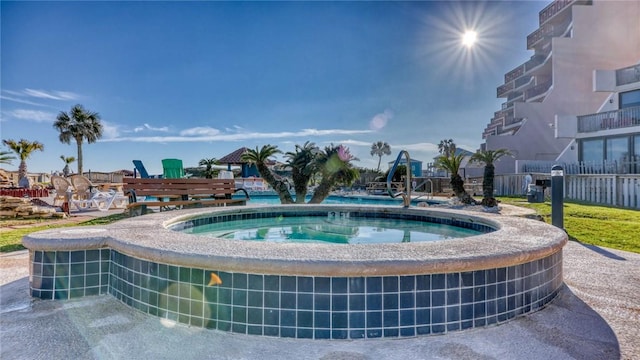 view of pool featuring an in ground hot tub