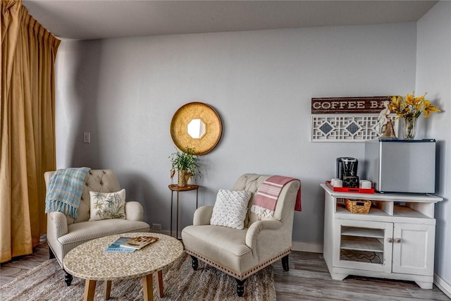 sitting room with hardwood / wood-style flooring