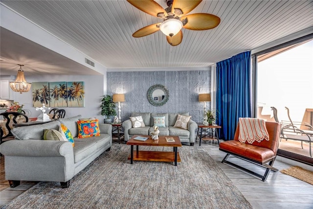 living room with wood-type flooring and a notable chandelier