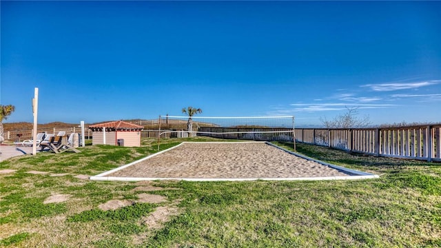 view of home's community featuring volleyball court and a lawn