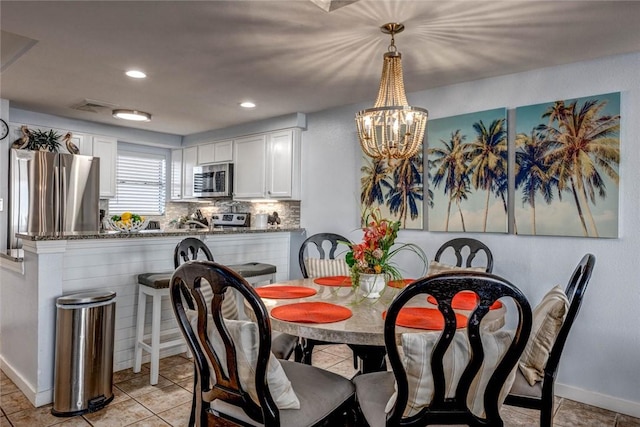 dining room featuring an inviting chandelier and light tile patterned flooring