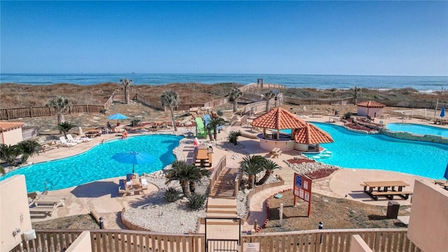 view of swimming pool featuring a water view, a patio area, and a gazebo