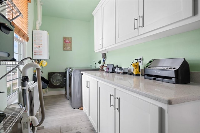 108 Bayshore Drive, Ingleside On The Bay, TX 78362 - washroom featuring plenty of natural light, light wood-type flooring, and washer and clothes dryer