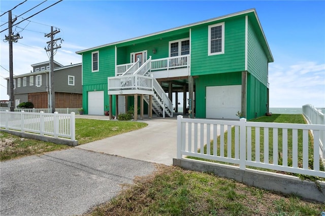 108 Bayshore Drive, Ingleside On The Bay, TX 78362 - beach home featuring a garage, stairs, a porch, and driveway