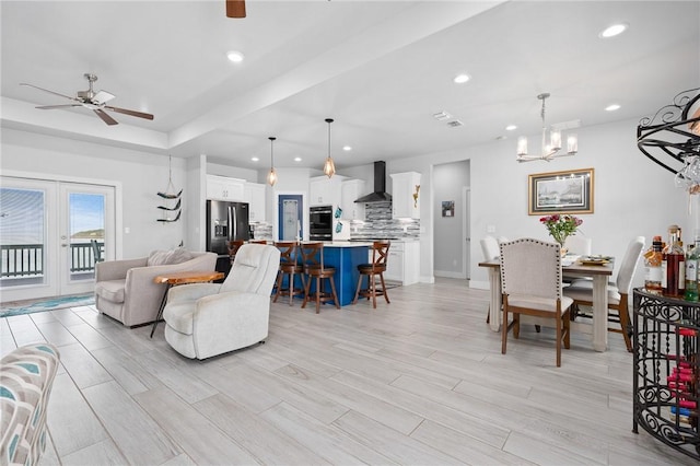 108 Bayshore Drive, Ingleside On The Bay, TX 78362 - living room with a ceiling fan, recessed lighting, light wood finished floors, a chandelier, and a tray ceiling