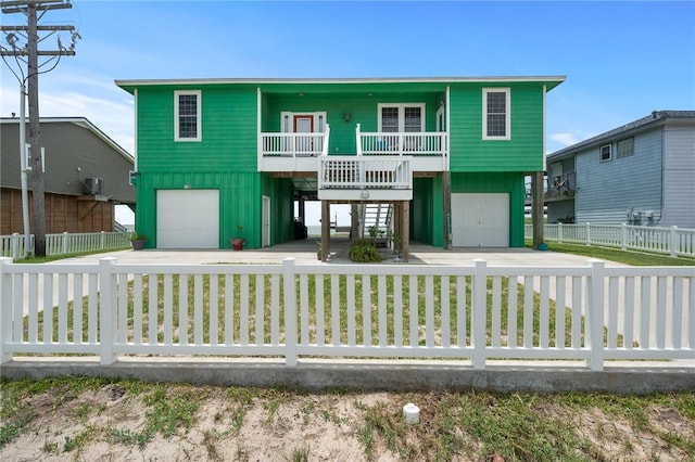108 Bayshore Drive, Ingleside On The Bay, TX 78362 - coastal inspired home with a garage, stairs, board and batten siding, and a fenced front yard