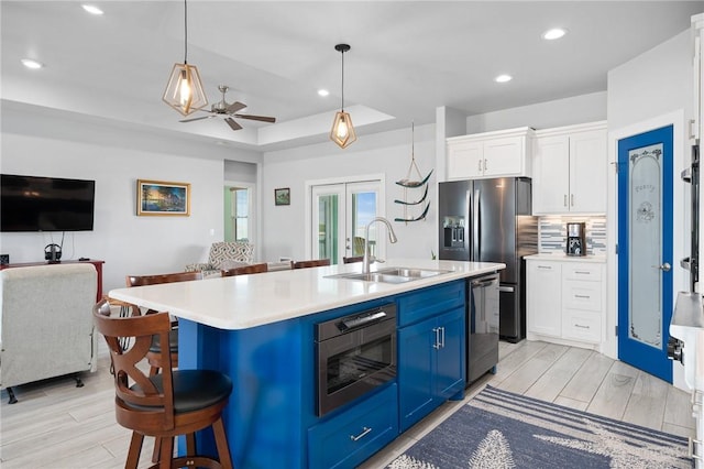 108 Bayshore Drive, Ingleside On The Bay, TX 78362 - kitchen featuring a sink, open floor plan, blue cabinetry, appliances with stainless steel finishes, and light countertops