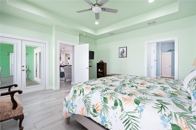108 Bayshore Drive, Ingleside On The Bay, TX 78362 - bedroom featuring french doors, a tray ceiling, light wood-style floors, recessed lighting, and a ceiling fan