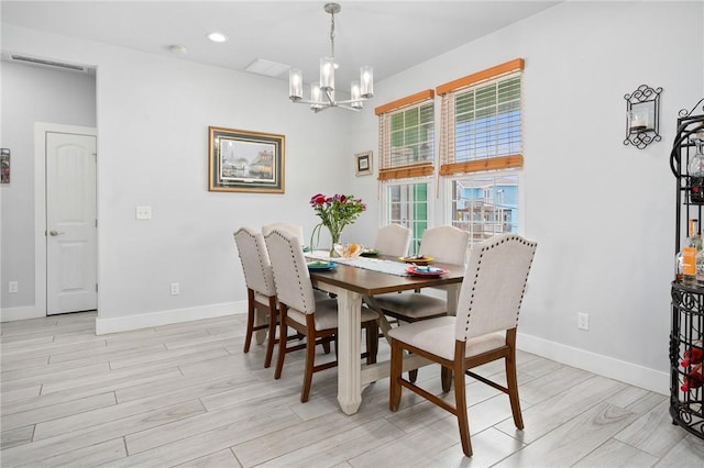 108 Bayshore Drive, Ingleside On The Bay, TX 78362 - dining space featuring a chandelier, light wood finished floors, and baseboards