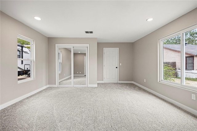 1437 14th St, Corpus Christi, TX 78404 - unfurnished bedroom featuring light carpet, baseboards, and recessed lighting