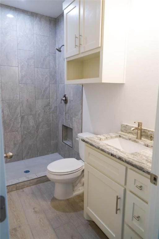 3525 Sahar Lk, Corpus Christi, TX 78380 - full bathroom featuring a shower stall, wood finished floors, vanity, and toilet