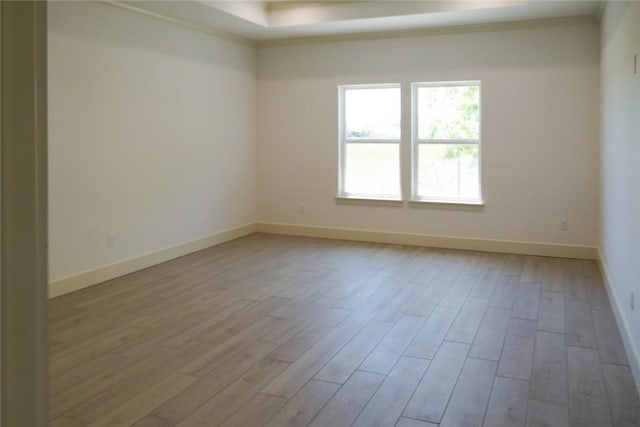 3525 Sahar Lk, Corpus Christi, TX 78380 - unfurnished room featuring a tray ceiling, wood finished floors, baseboards, and ornamental molding