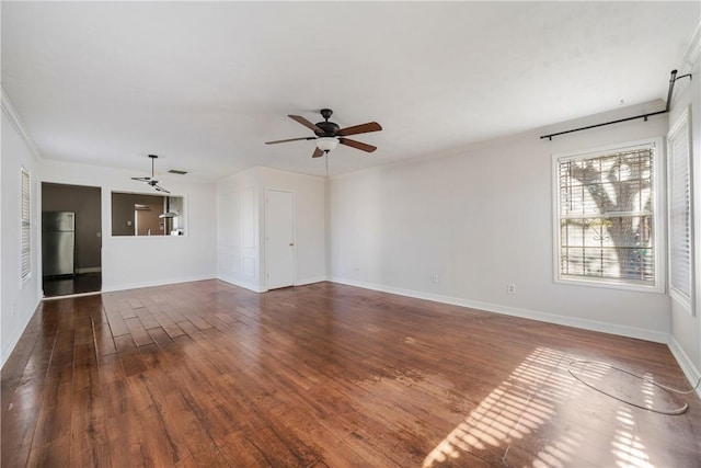 unfurnished room with ceiling fan, dark hardwood / wood-style flooring, and ornamental molding