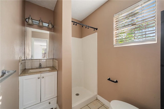 bathroom with tile patterned floors, walk in shower, toilet, and vanity