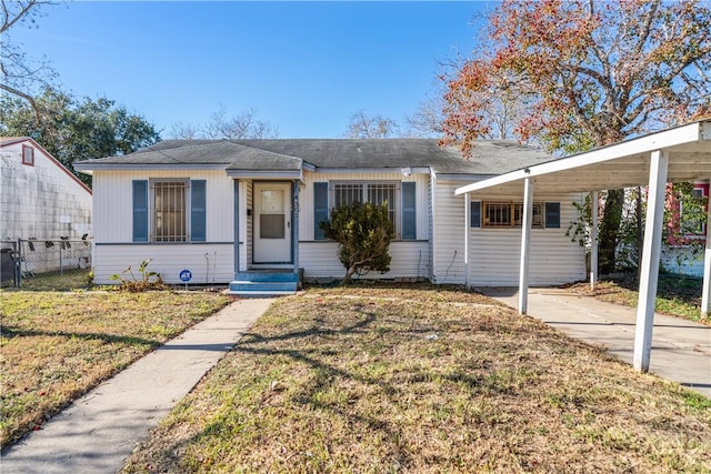 view of front of house with a front yard and a carport