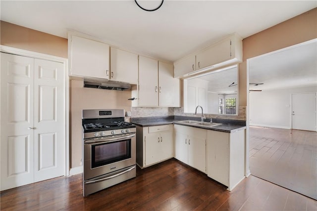 kitchen featuring tasteful backsplash, stainless steel gas range oven, sink, white cabinetry, and dark hardwood / wood-style flooring