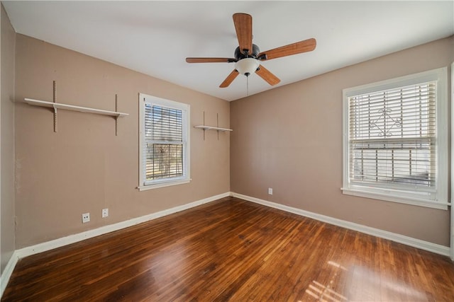 spare room with ceiling fan and dark hardwood / wood-style floors