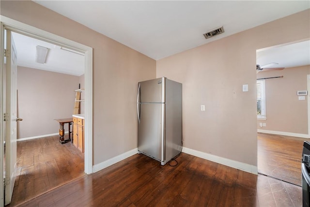 interior space featuring stainless steel fridge and hardwood / wood-style floors