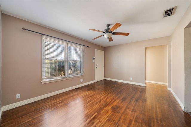 unfurnished room with ceiling fan and dark wood-type flooring