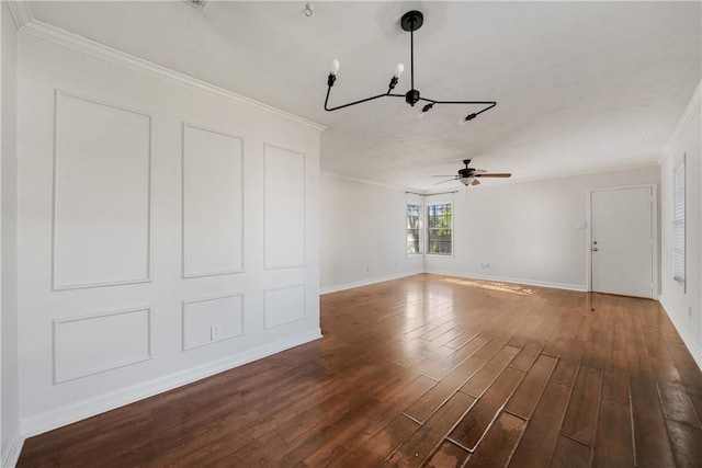 interior space featuring dark hardwood / wood-style floors, ceiling fan with notable chandelier, and ornamental molding