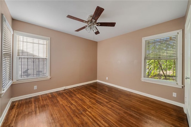 spare room with ceiling fan and dark hardwood / wood-style floors