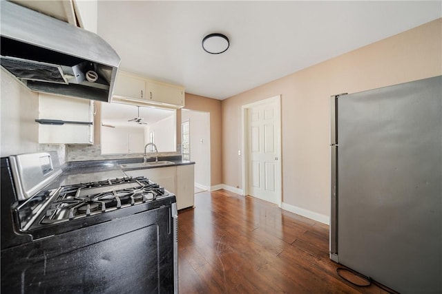 kitchen featuring exhaust hood, dark hardwood / wood-style floors, decorative backsplash, sink, and appliances with stainless steel finishes