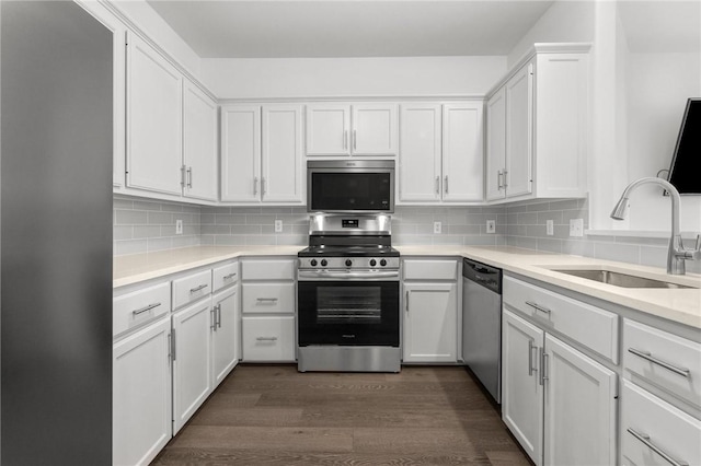 13901 Mingo Cay Ct Unit F, Corpus Christi, TX 78418 - kitchen featuring stainless steel appliances, a sink, dark wood-style floors, light countertops, and white cabinets