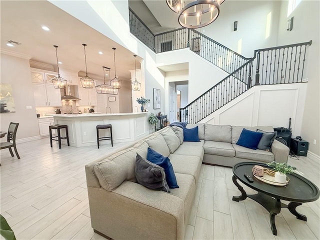 8137 Berenstain Dr, Corpus Christi, TX 78414 - living area featuring a chandelier, a high ceiling, light wood-type flooring, recessed lighting, and stairway