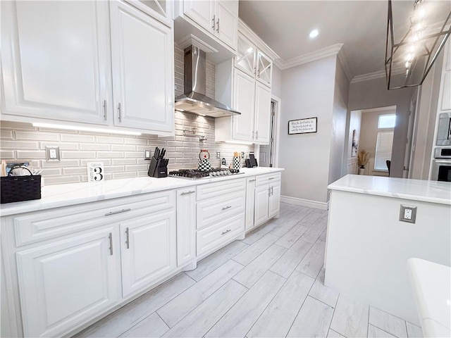 8137 Berenstain Dr, Corpus Christi, TX 78414 - kitchen with wall chimney exhaust hood, stainless steel appliances, baseboards, white cabinets, and glass insert cabinets