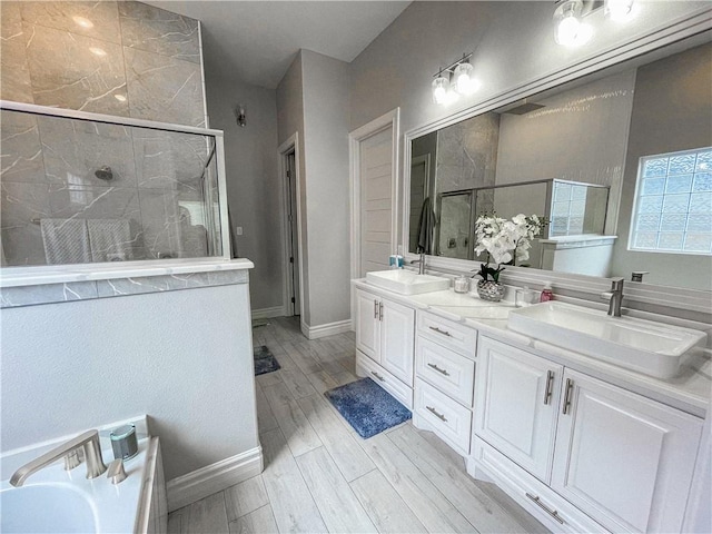 8137 Berenstain Dr, Corpus Christi, TX 78414 - full bathroom featuring a stall shower, wood finished floors, double vanity, and baseboards