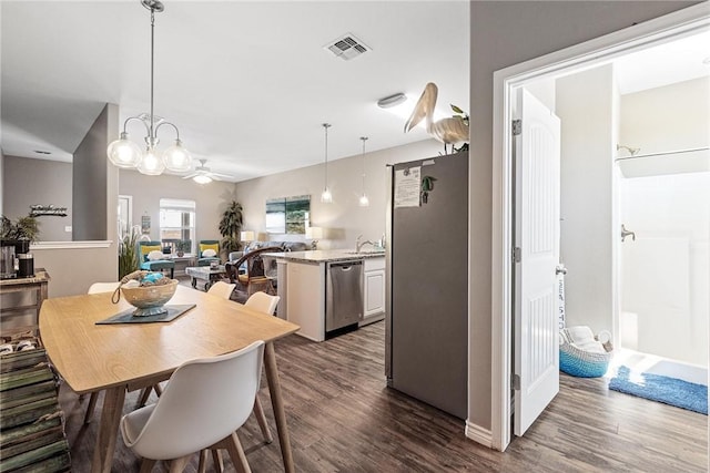 dining room with dark wood-style floors, ceiling fan, and visible vents