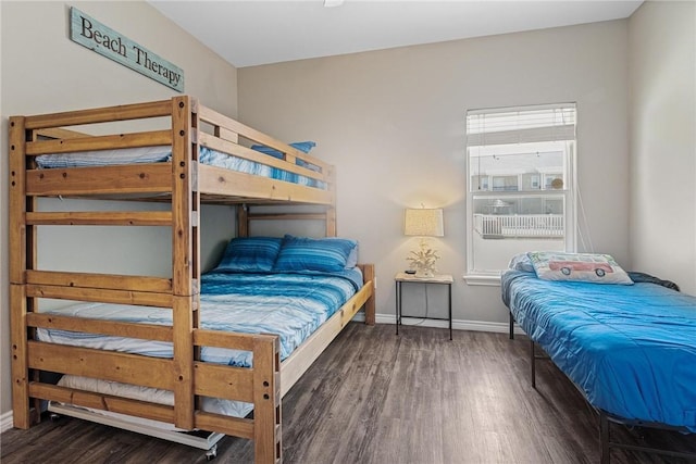 bedroom with baseboards and wood finished floors