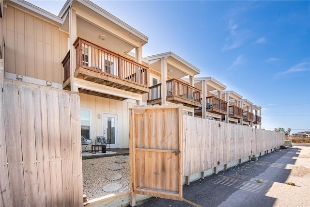 view of property exterior with board and batten siding and a balcony