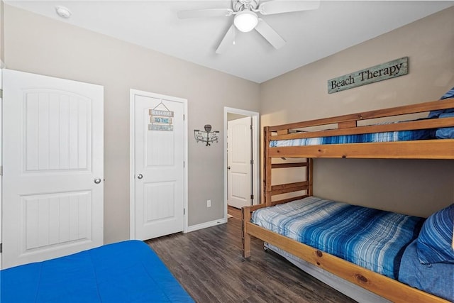 bedroom with ceiling fan, baseboards, and wood finished floors