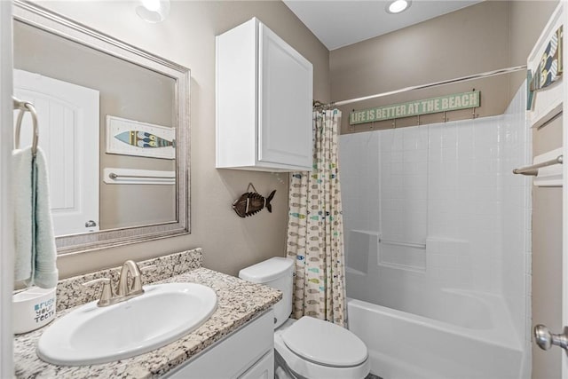 full bathroom with shower / tub combo with curtain, vanity, and toilet