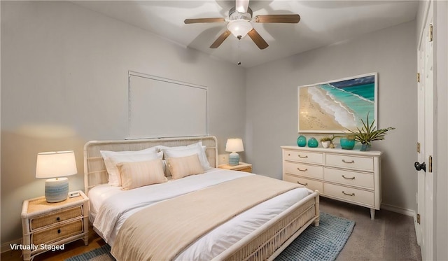 bedroom featuring dark colored carpet and a ceiling fan