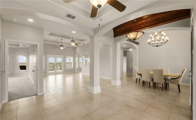 interior space featuring light tile patterned flooring and ceiling fan with notable chandelier