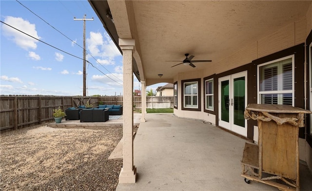 view of patio featuring ceiling fan, french doors, a fenced backyard, and an outdoor living space