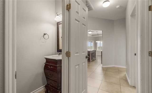 bathroom featuring vanity, tile patterned flooring, visible vents, and baseboards