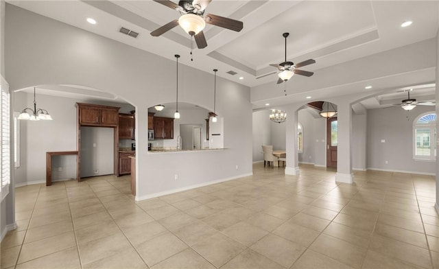 14149 Coquina Bay Ave, Corpus Christi, TX 78418 - unfurnished living room featuring arched walkways, a ceiling fan, a chandelier, light tile patterned floors, and recessed lighting