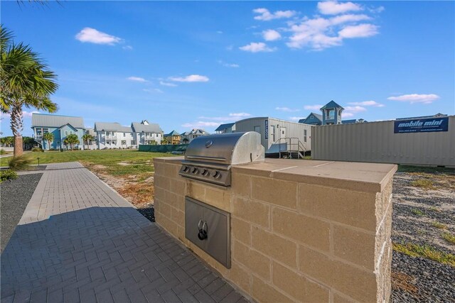view of patio with area for grilling and a residential view