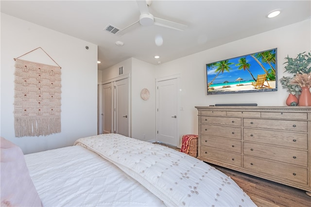 bedroom featuring wood-type flooring, ceiling fan, and a closet