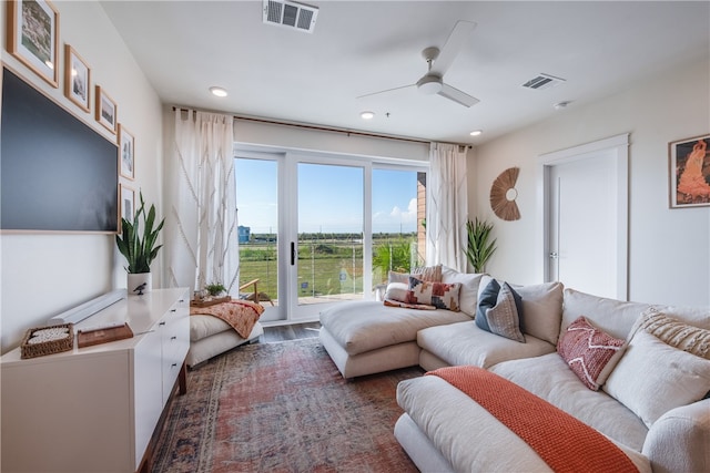 living room with dark hardwood / wood-style flooring and ceiling fan