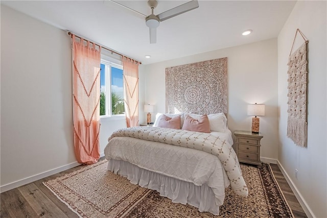 bedroom with a ceiling fan, wood finished floors, and baseboards