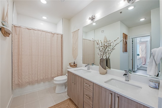 full bathroom with toilet, vanity, shower / bath combo with shower curtain, and tile patterned flooring