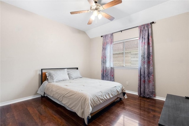 bedroom featuring dark hardwood / wood-style flooring, vaulted ceiling, and ceiling fan