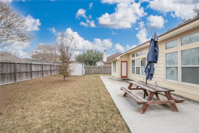 view of yard featuring a patio and a storage unit