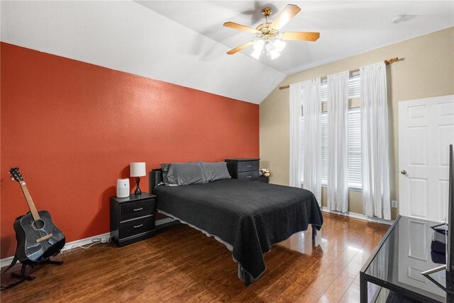 bedroom featuring lofted ceiling, wood-type flooring, and ceiling fan